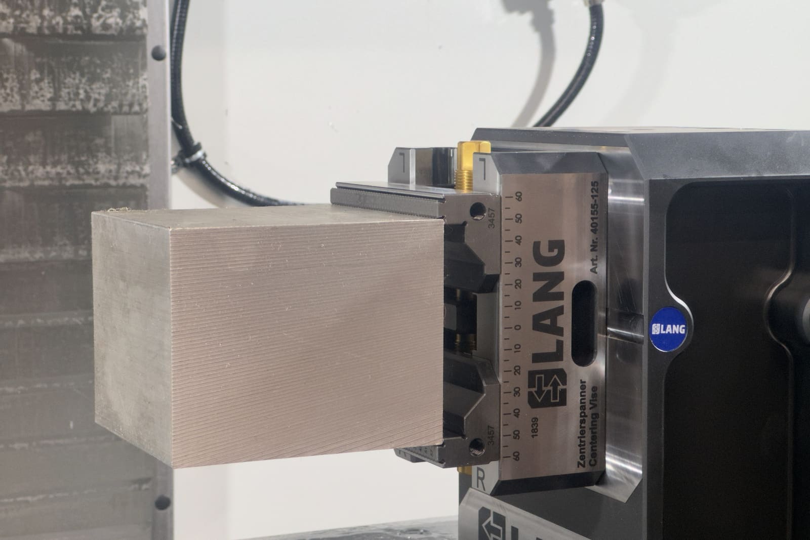 Aluminum stock clamped in a Lang centering vise